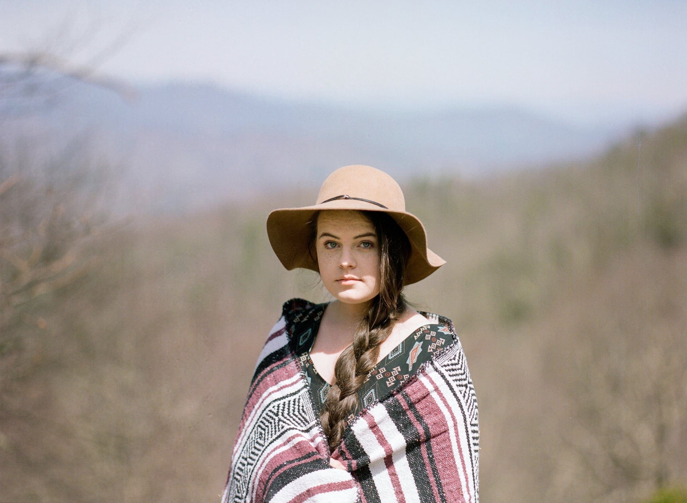 Film-Portra 400, Asheville Film Photography, Blue Ridge Parkway, teen in hat with hair braided, boho blanket, Blue Ride Mountains, Headshot