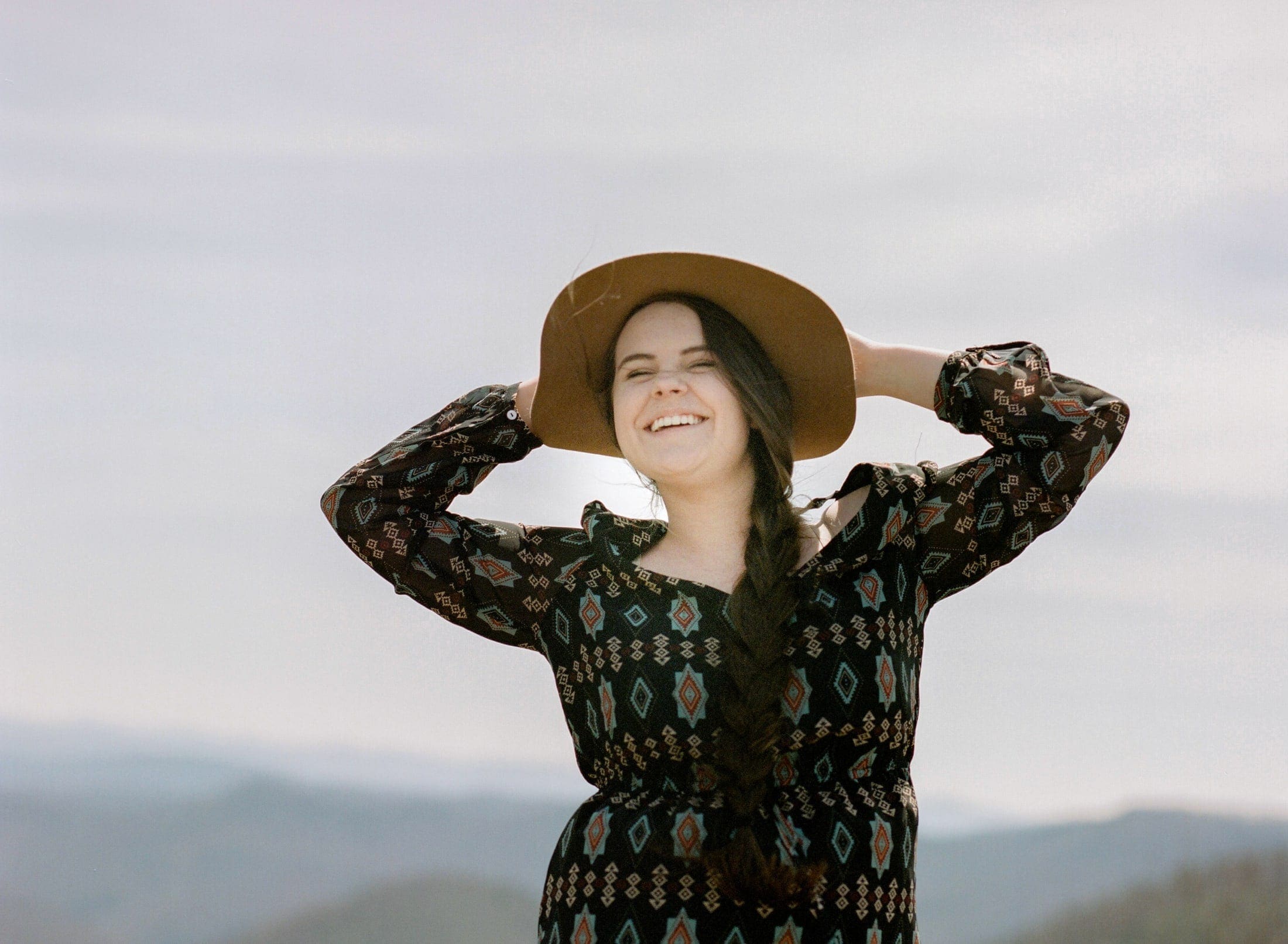 Film-Portra 400, Asheville Film Photography, Blue Ridge Parkway, Mountains in background, girl in hat laughing