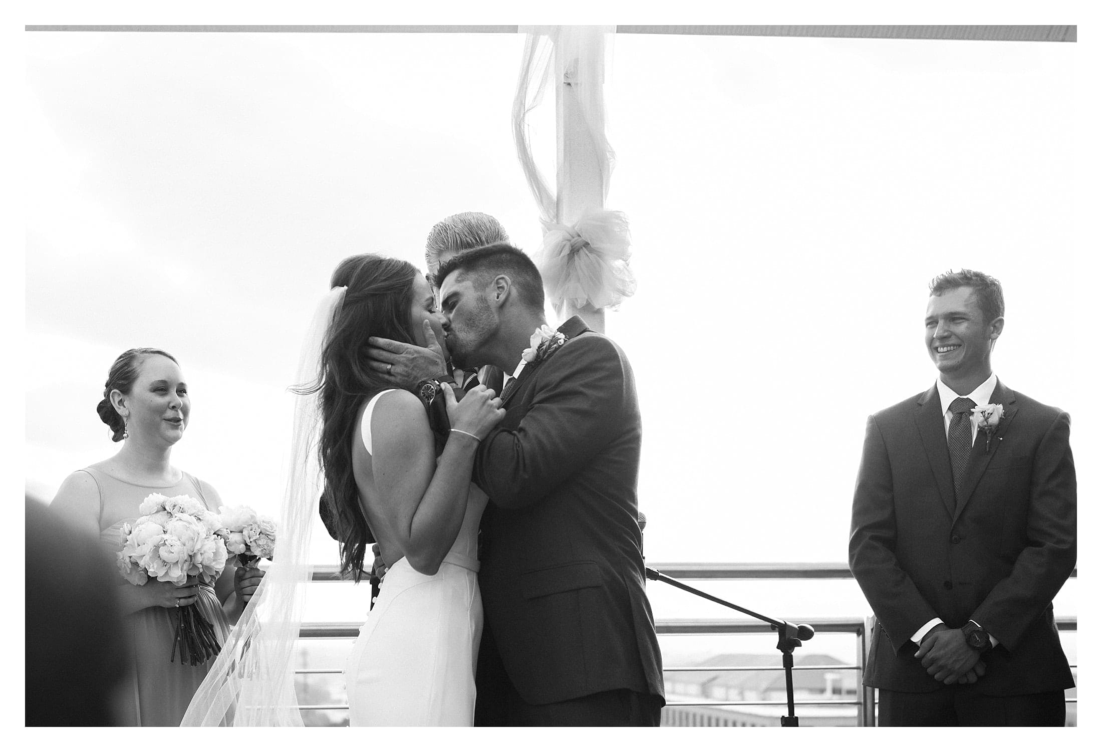 The bride and groom kiss after saying I do.