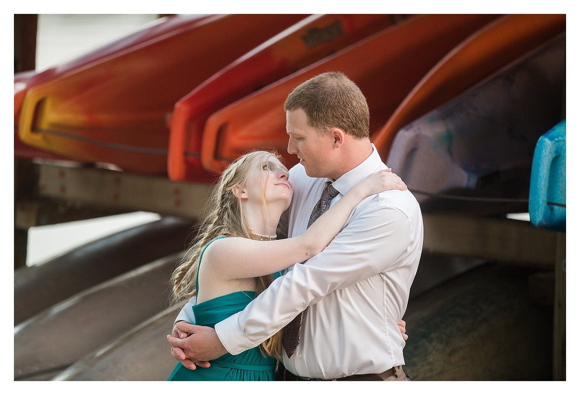 Bride and Groom portrait in front of kayaks