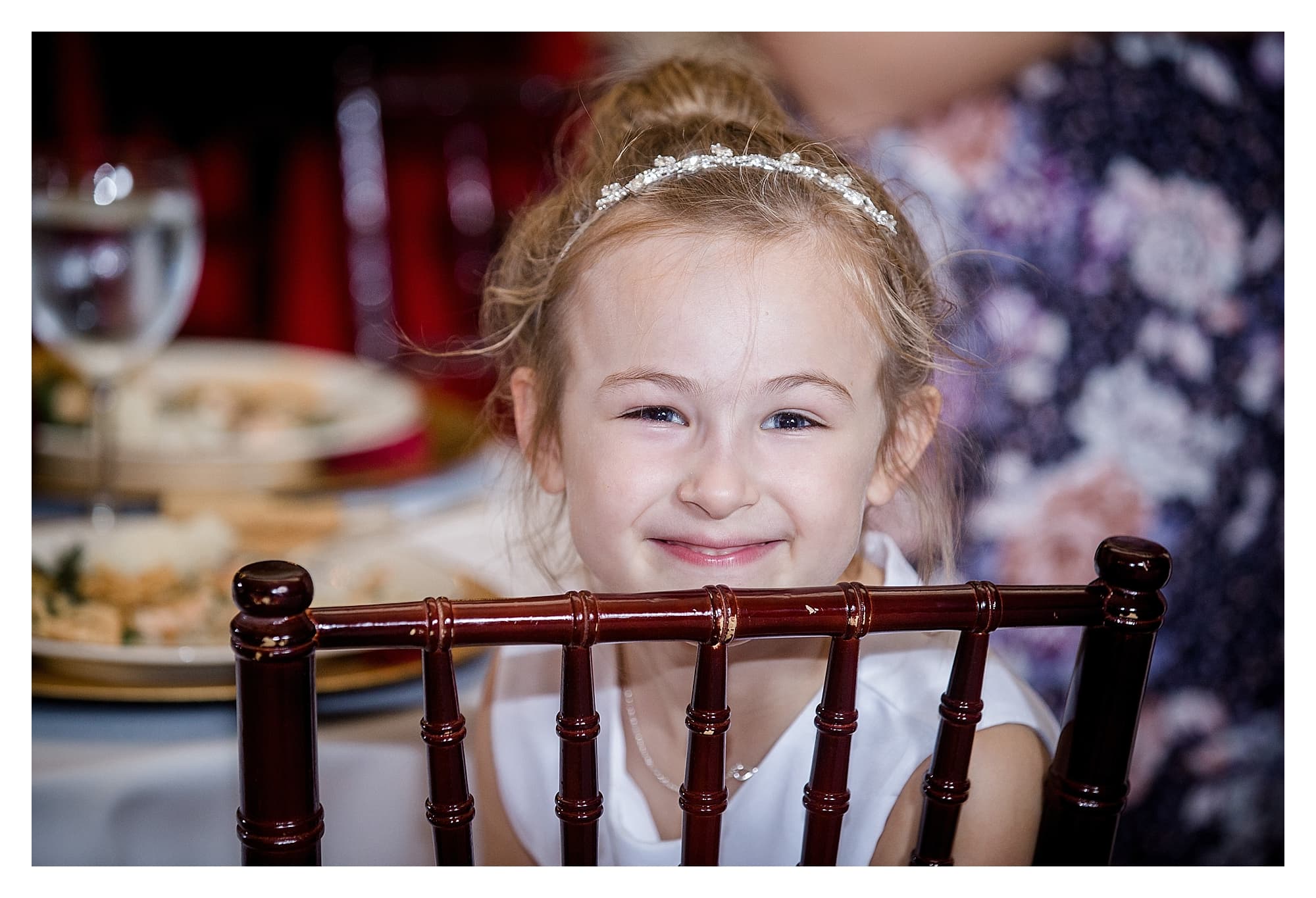 Smiling girl at wedding reception, photography by Kathy Beaver