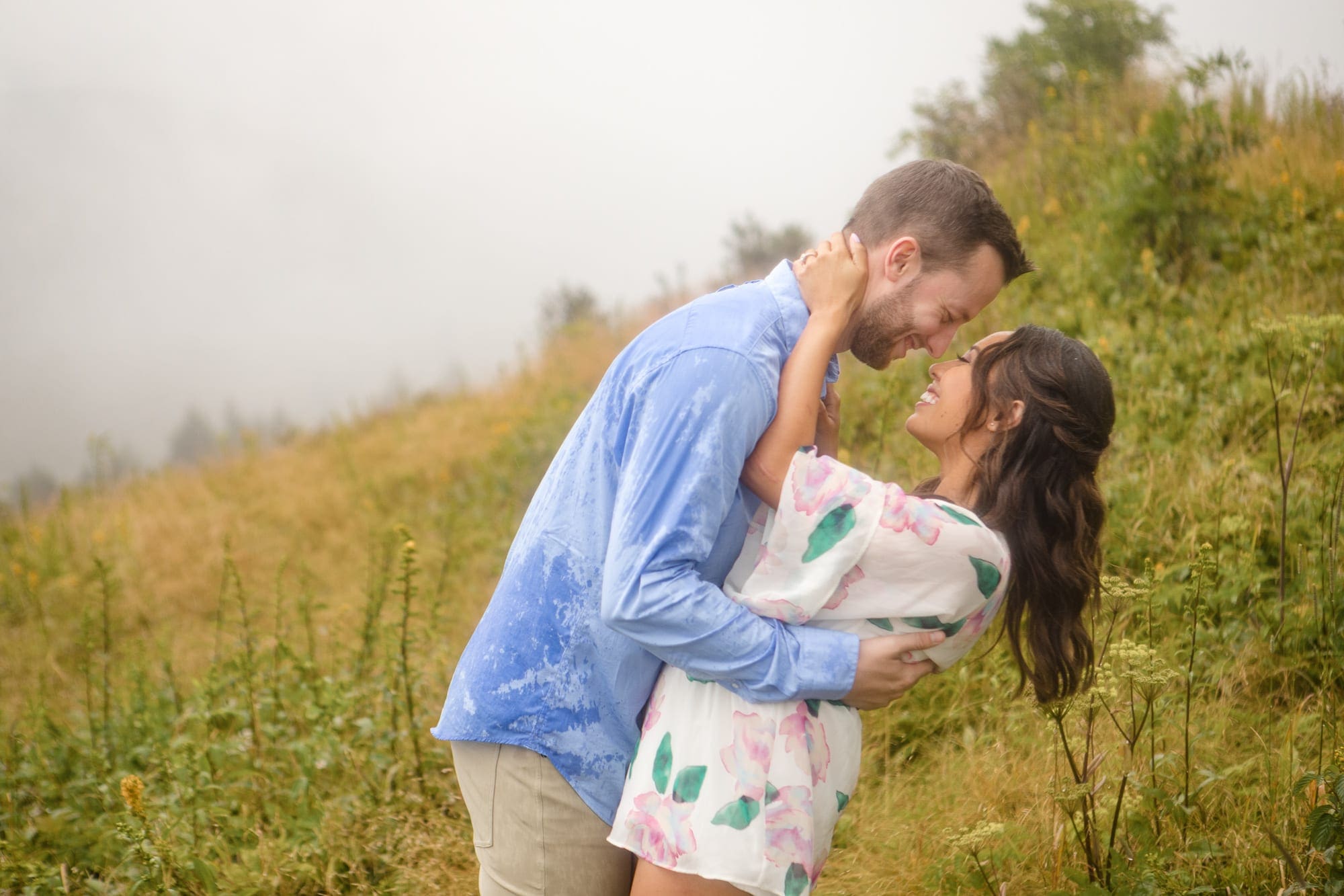 Couple embracing in mountain's valley on foggy day near Asheville North Carolina photography done by Kathy Beaver.