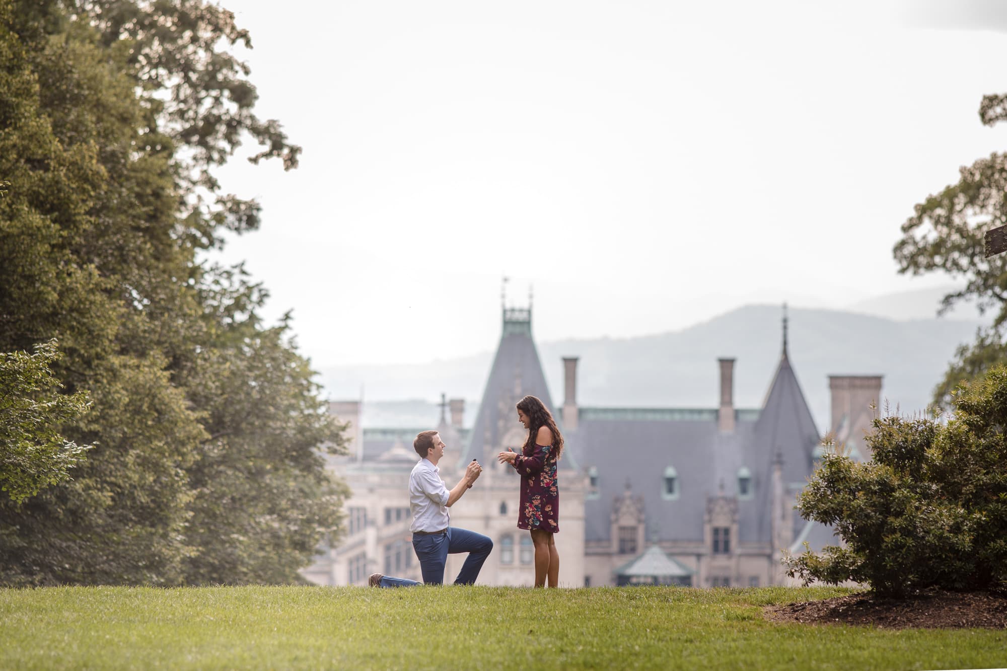 Man proposing to woman in front of Biltmore Estate North Carolina photography done by Kathy Beaver.