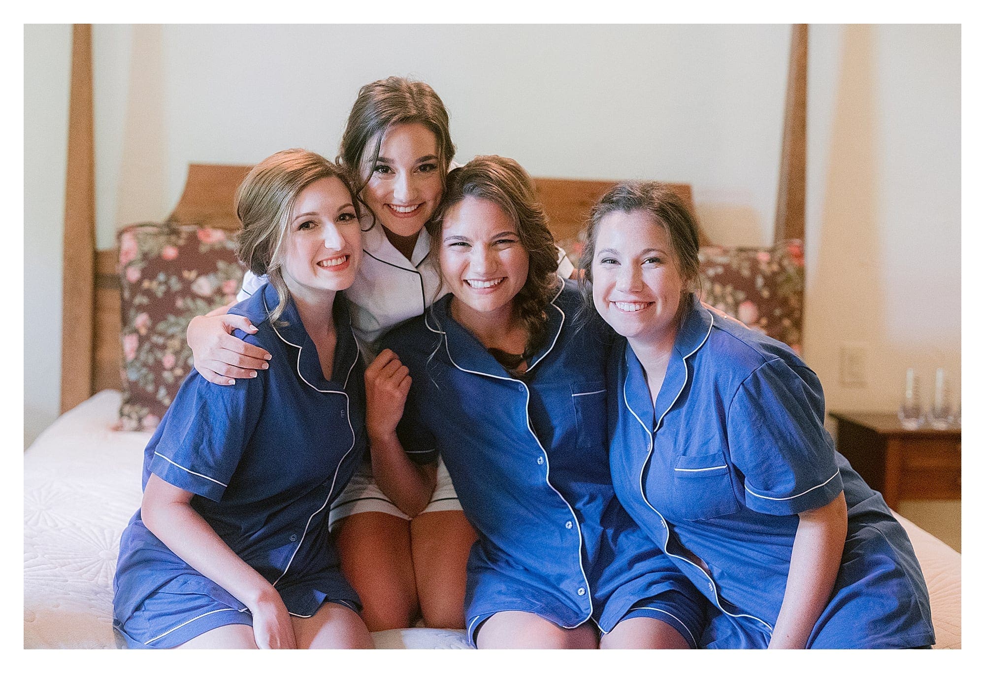 Bride and bridesmaids in matching pyjama sets before putting dresses on
