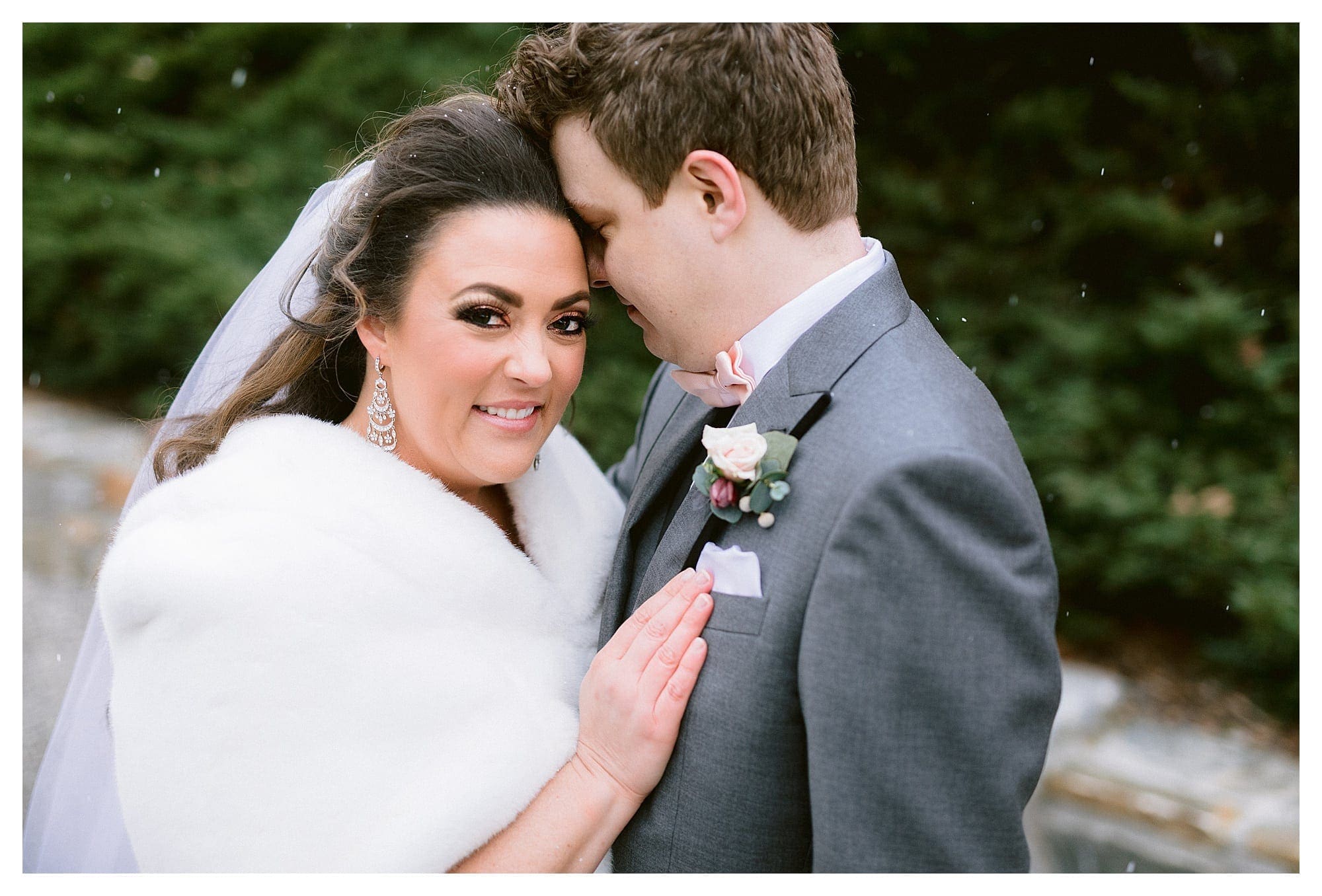 Bride and groom hugging in the snow