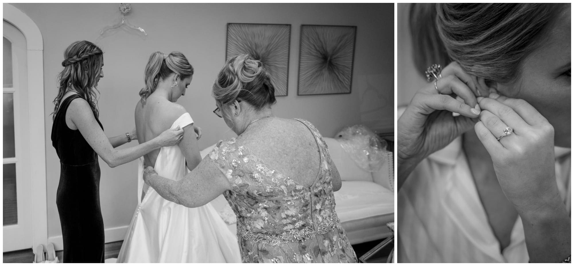 mom and sister help bride into dress
