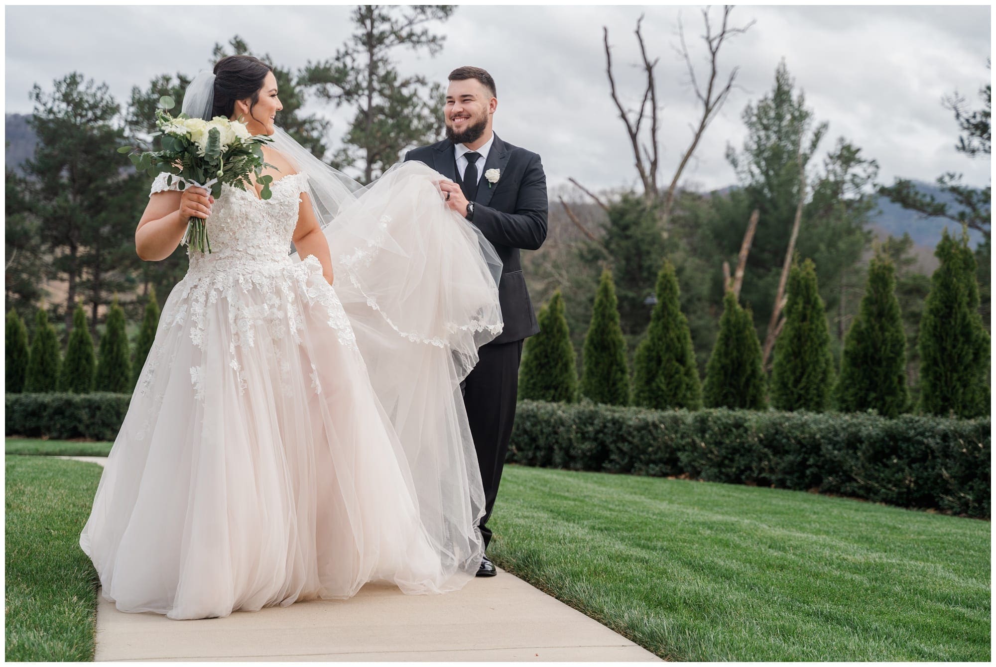 goom helps bride with her dress
