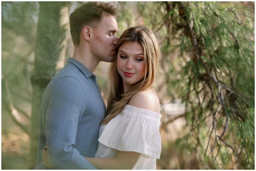 Eric kisses Fallon on the temple during their engagement session.