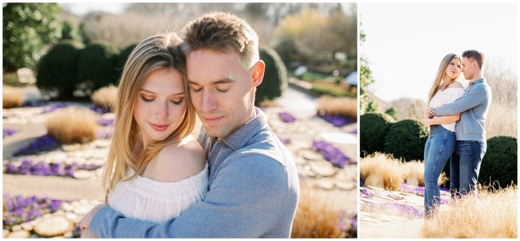 The couple hugging one another with purple flowers in the background.