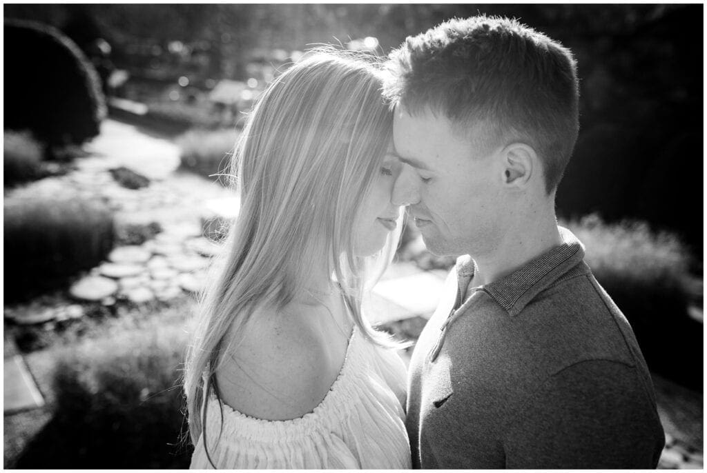 Intimate black and white photo of couple with their noses touching.