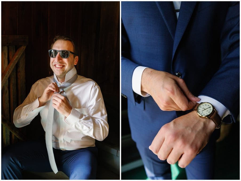 The groom putting on his tie and watch before the wedding.