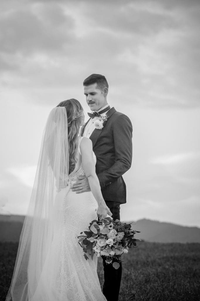 Black and white photo of the groom looking down at his bride | Kathy Beaver Photography | Asheville Wedding Photographer