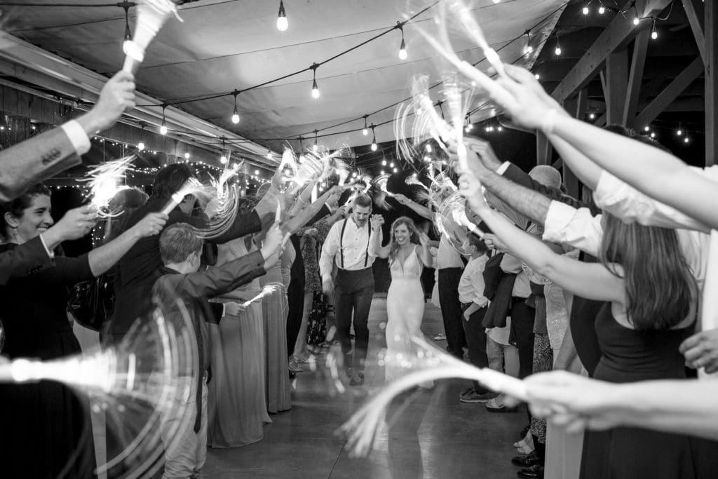 Black and white photo of their exit with LED Sparklers | Kathy Beaver Photography | Asheville Wedding Photographer