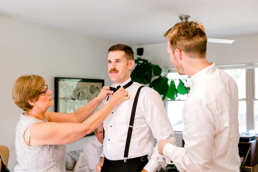 The mom helps the groom adjust his bow tie | Kathy Beaver Photography | Asheville Wedding Photographer