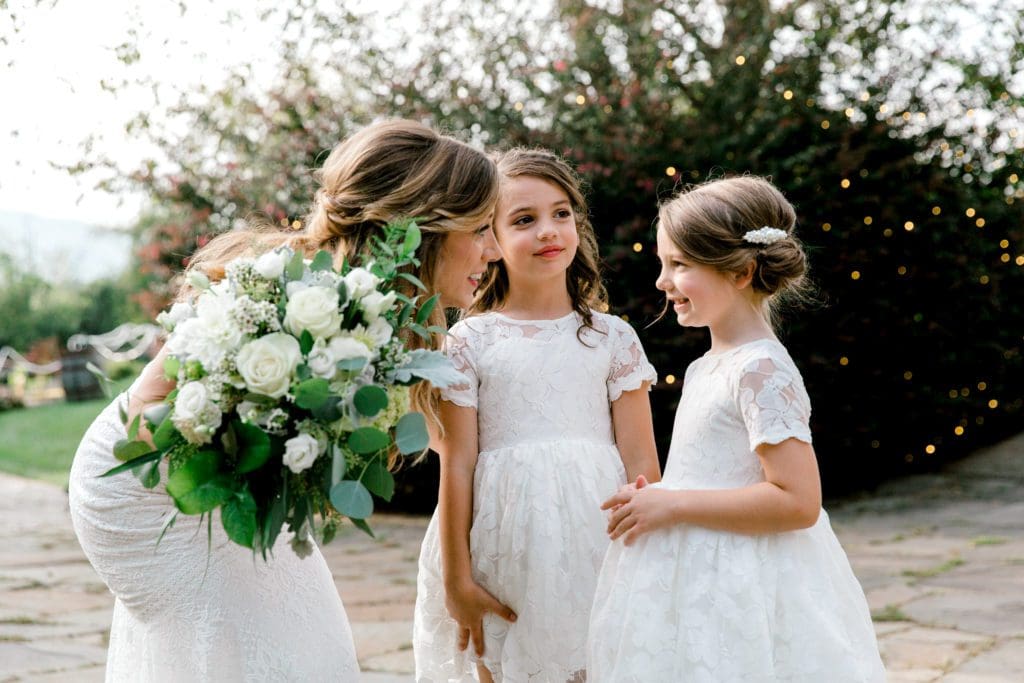 The bride smiles with her flower girls  | Kathy Beaver Photography | Asheville Wedding Photographer
