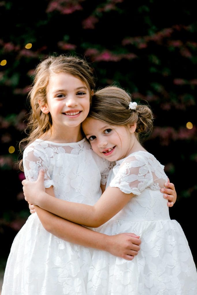 A photo of the two flower girls hugging | Kathy Beaver Photography | Asheville Wedding Photographer