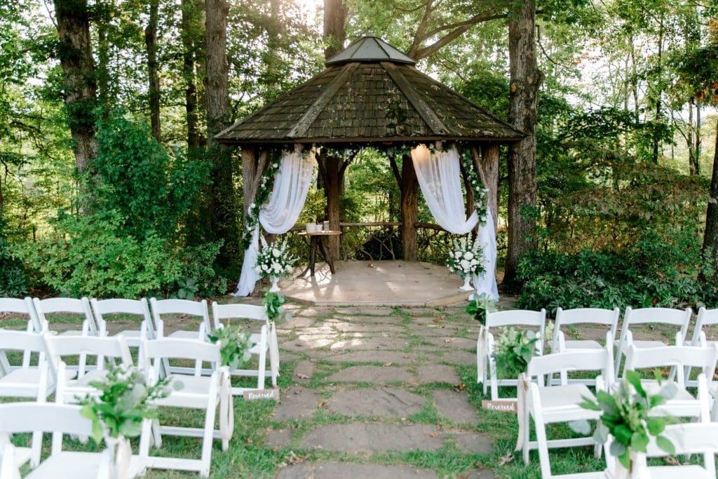 Ceremony decor with green and white flowers under a gazebo | Kathy Beaver Photography | Asheville Wedding Photographer