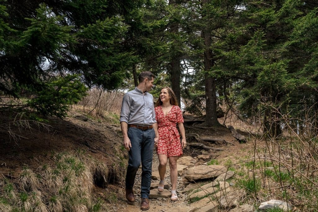 Sydney and David hold hands while walking the trail  | Asheville Engagement Photographer