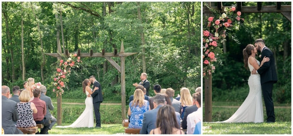 couple under arbor with flowers at asheville nc wedding - first kiss as husband and wife at their spring wedding at Junebug Retro Resort