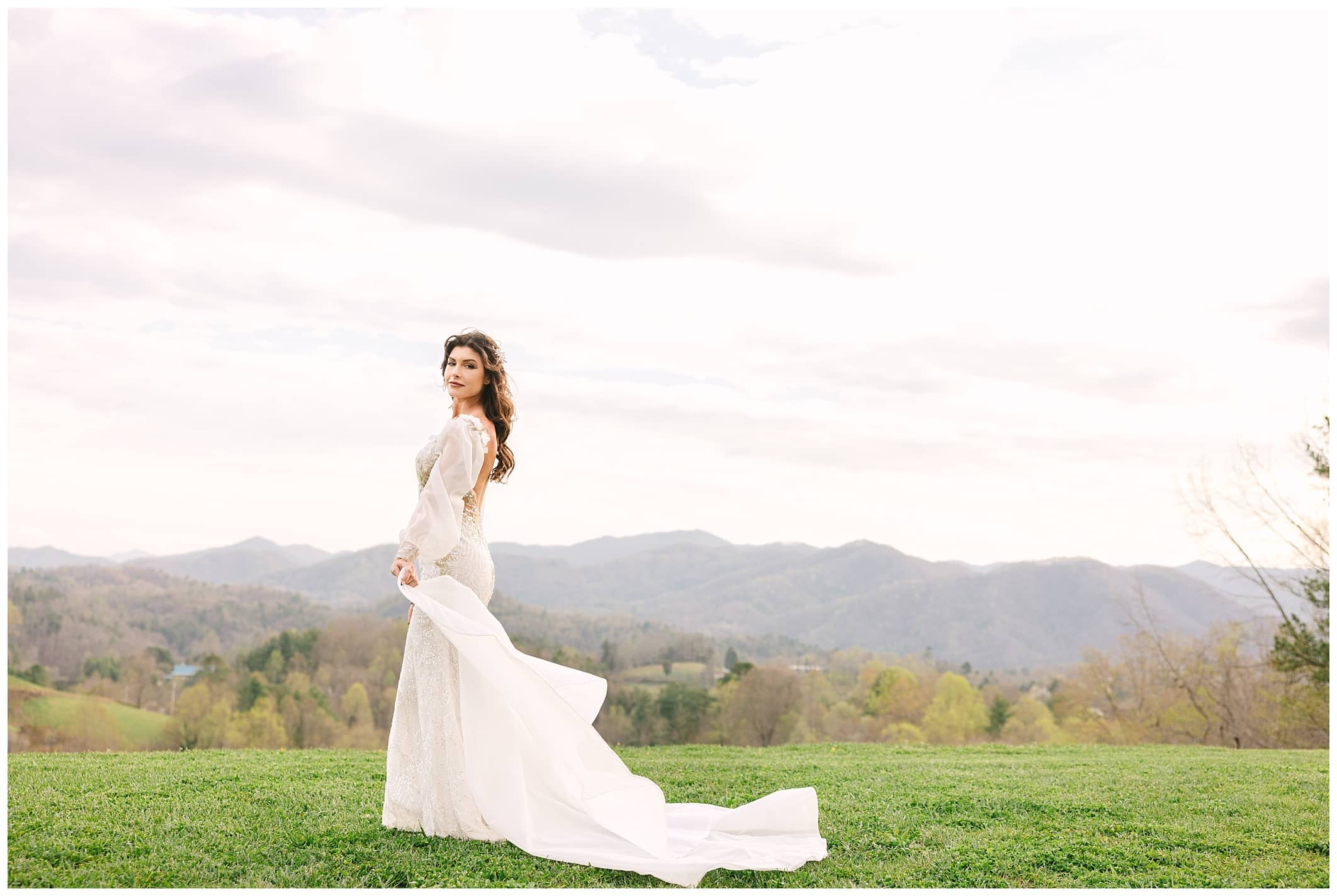 Custom wedding dress with puffy long sleeves, mermaid style and lace detail designed by Angela Kim Couture. Capture at The Ridge just outside of Asheville, North Carolina by Kathy Beaver Photography, a NC wedding photographer.