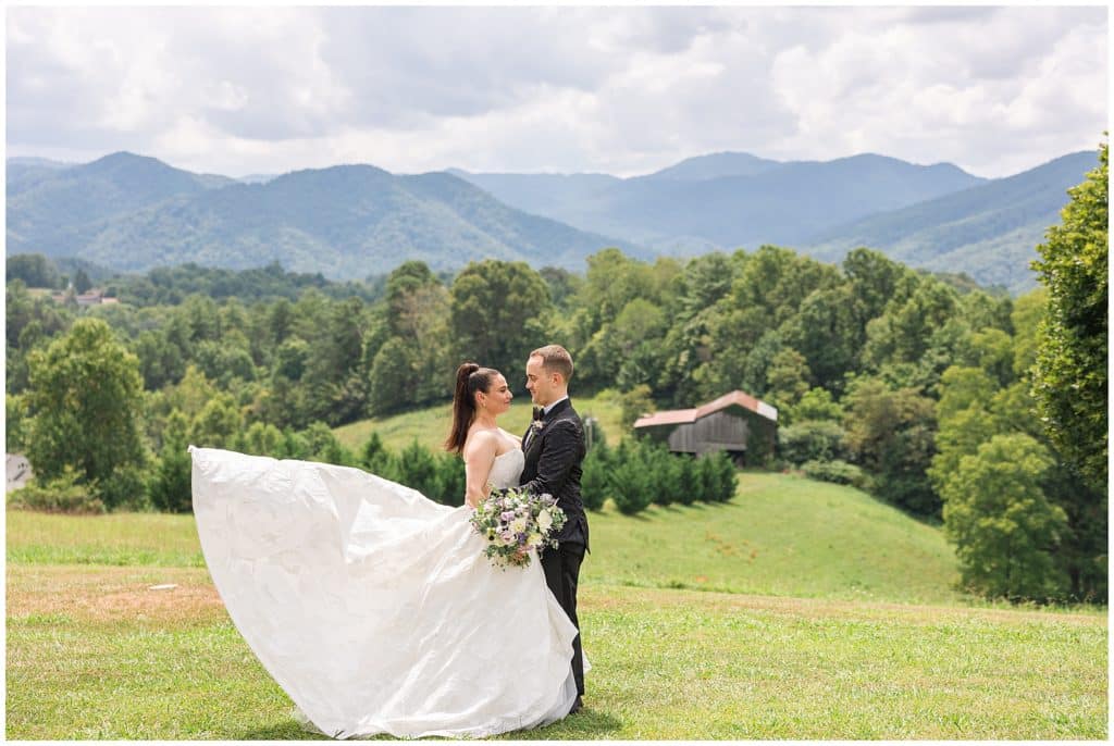 bride and groom portraits with mountains in background on a summer day