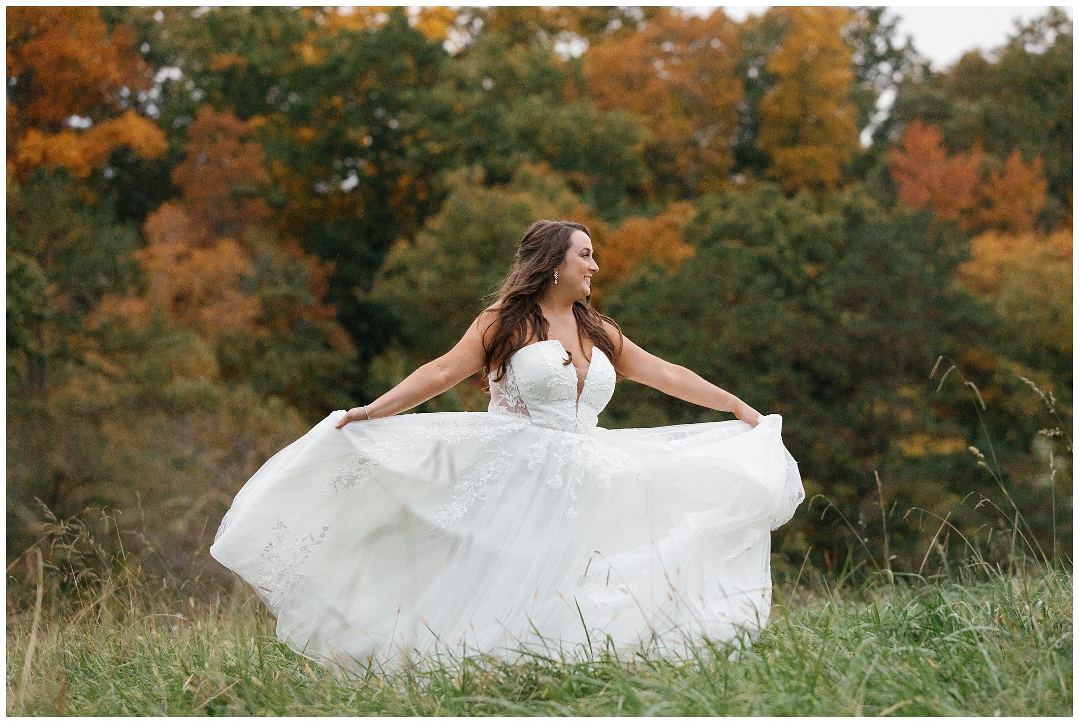 bride twirls around outdoors for her fall wedding