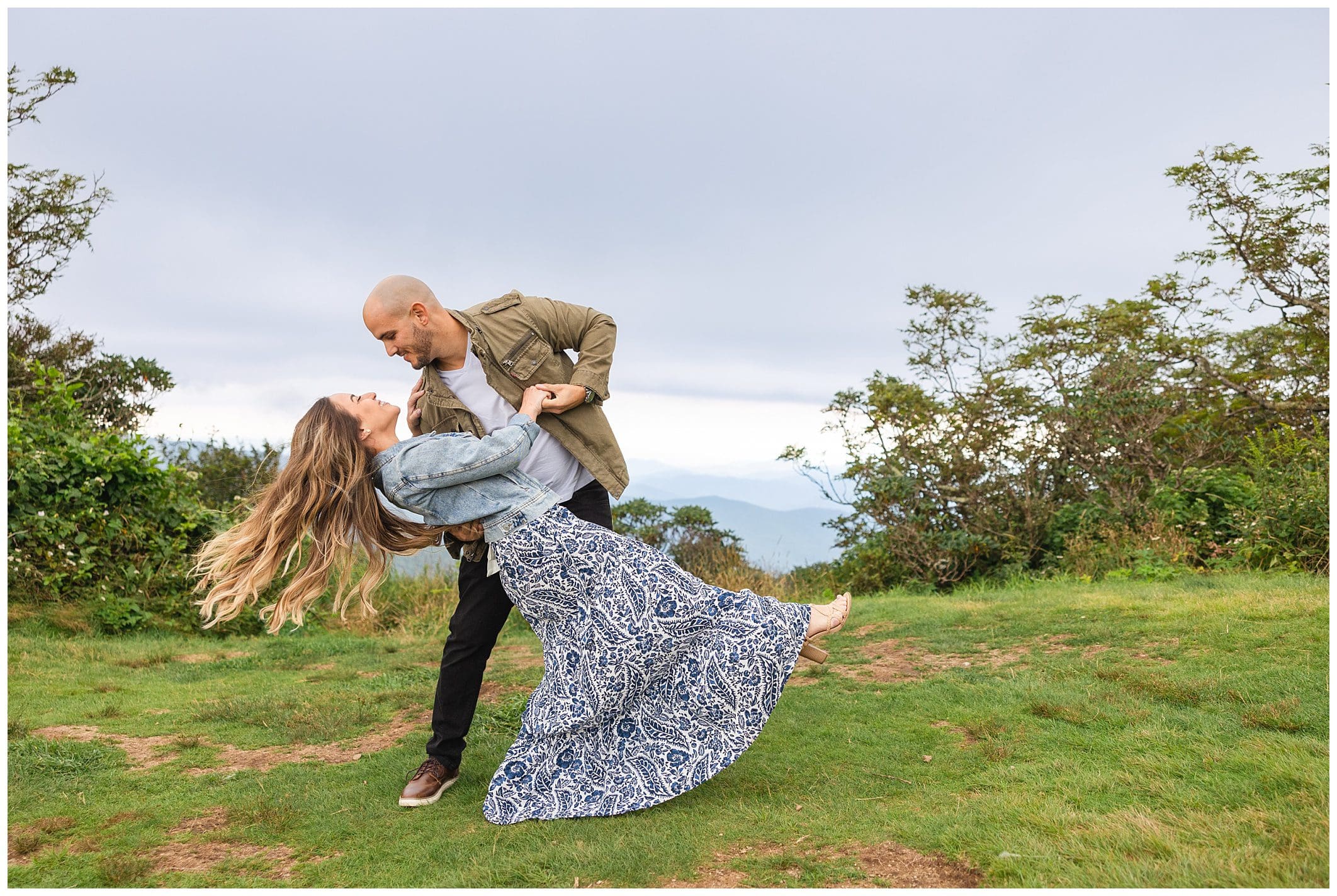 Couple dancing in the Blue Ridge mountains for their engagement session