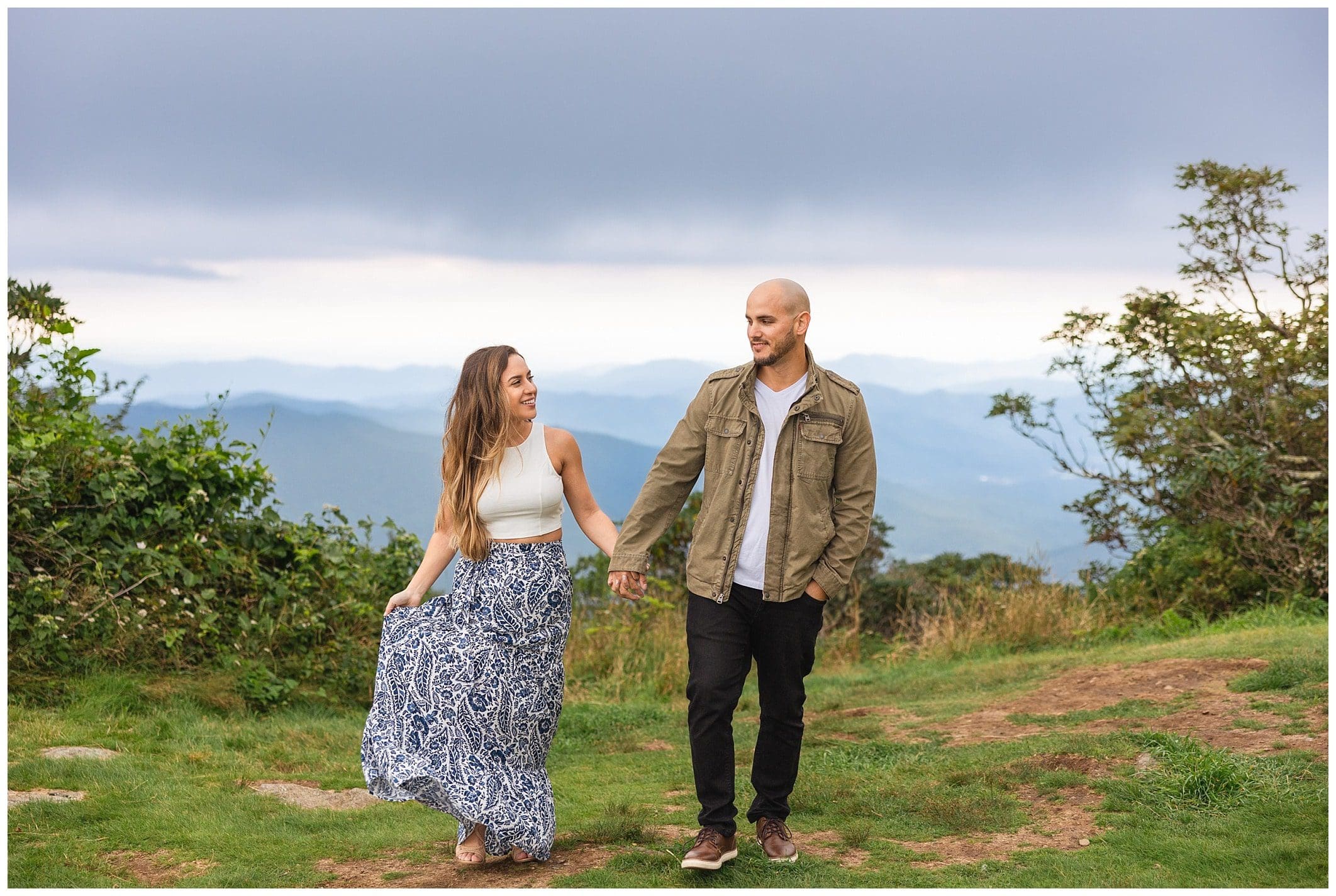 Couple walking together in front of the mountain backdrop for their Blue Ridge Parkway engagement session