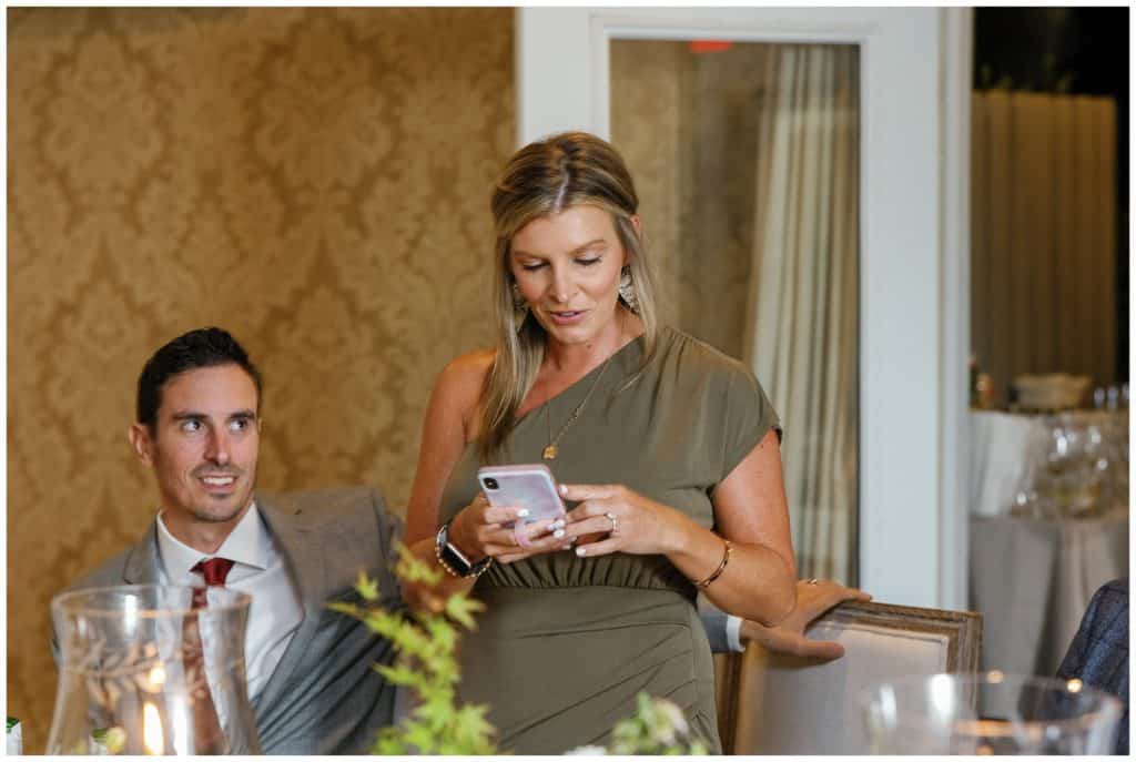 Bridesmaid reading her speech from her phone