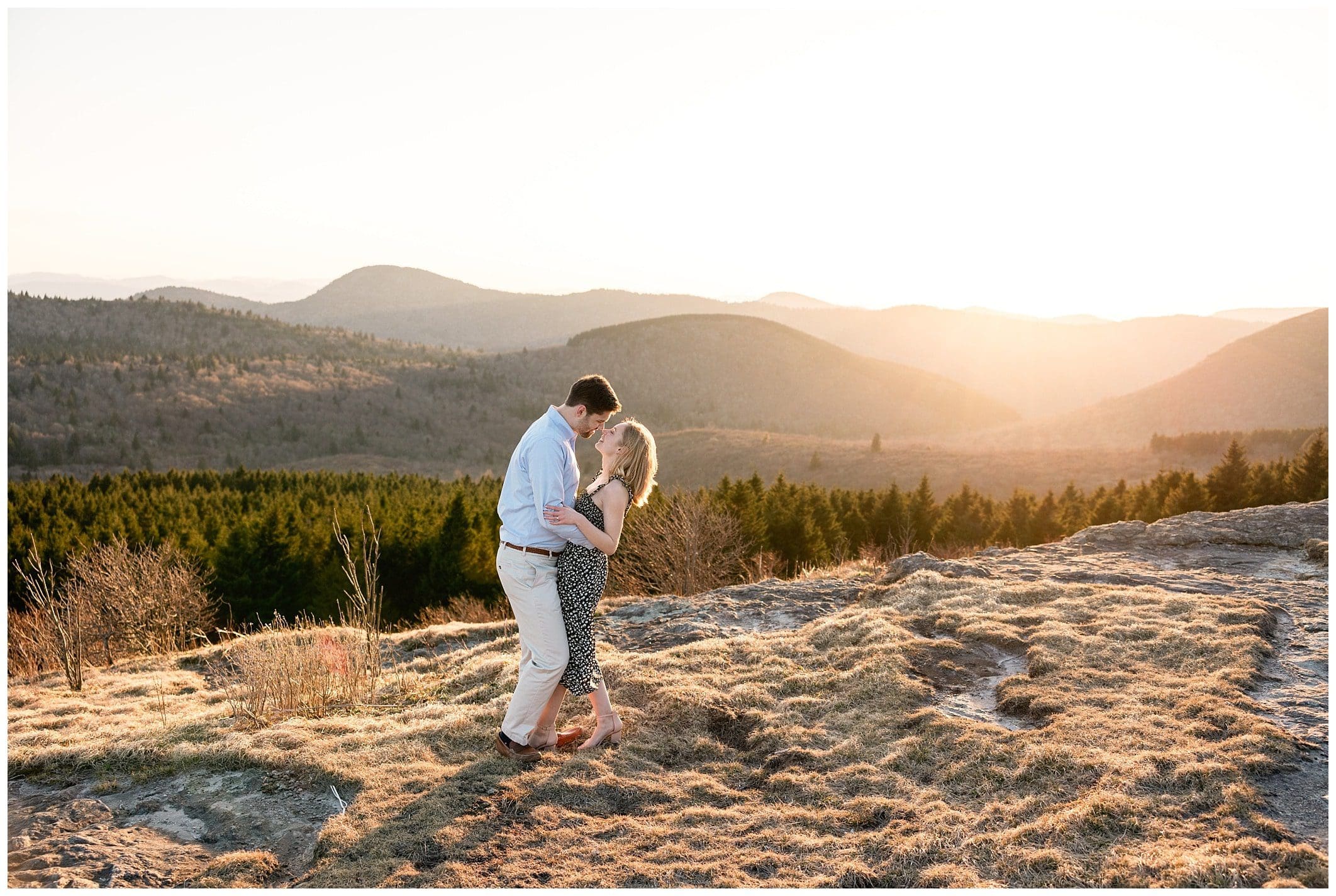 couple about to kiss with mountain views behind them