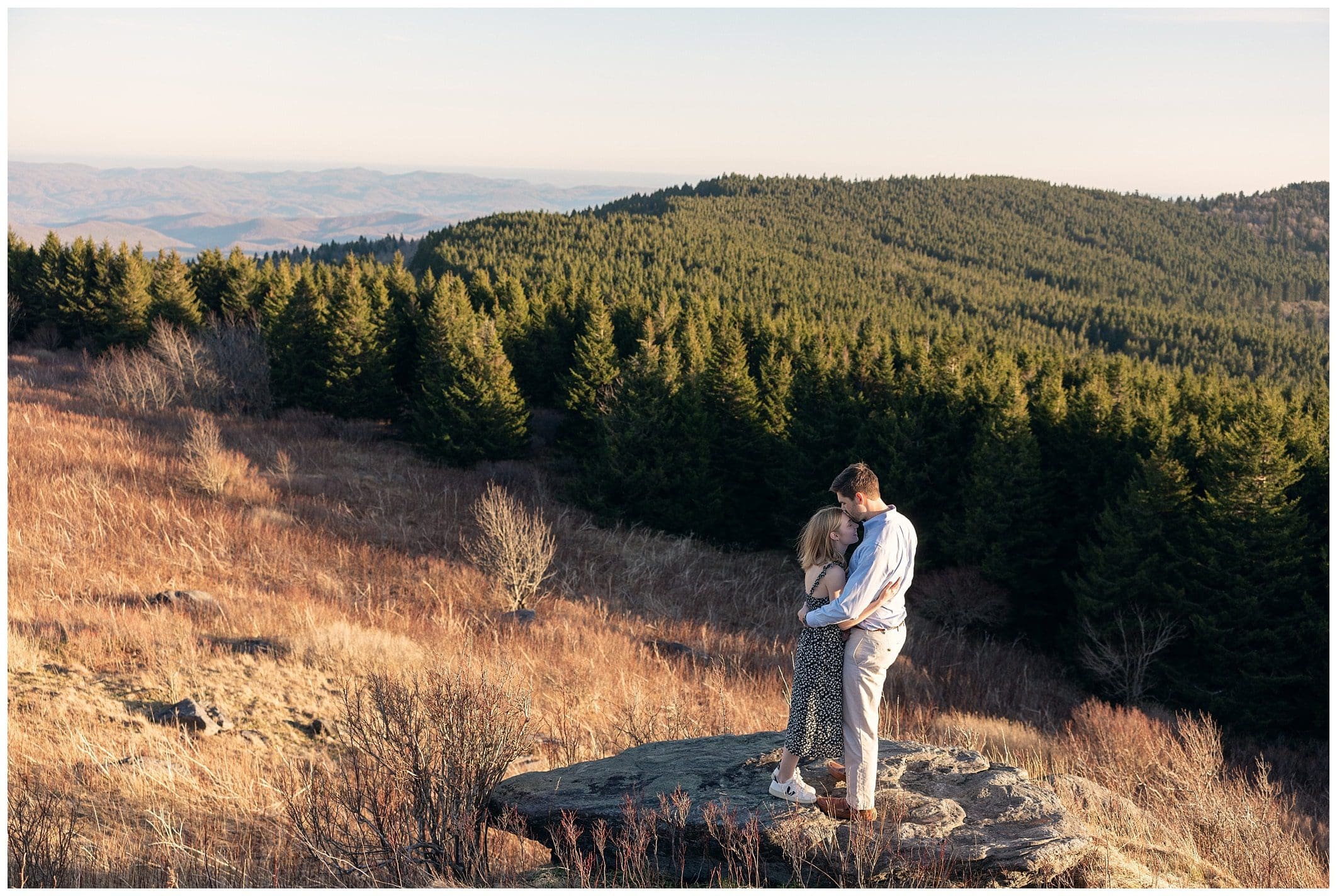 Couple hugs on top of a rock for their Black Balsam engagement session