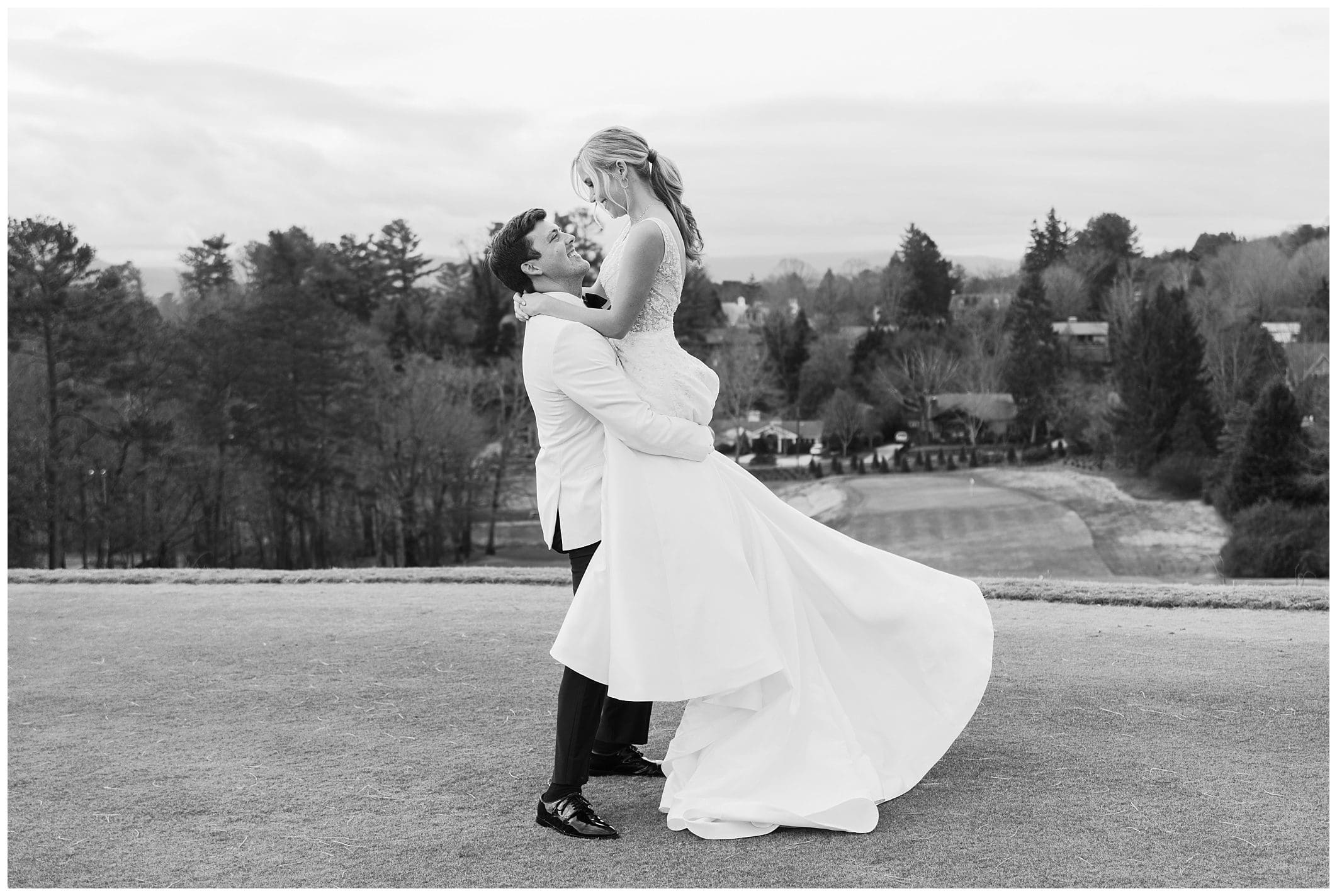 black and white photo of couple hugging outdoors at Asheville Country Club