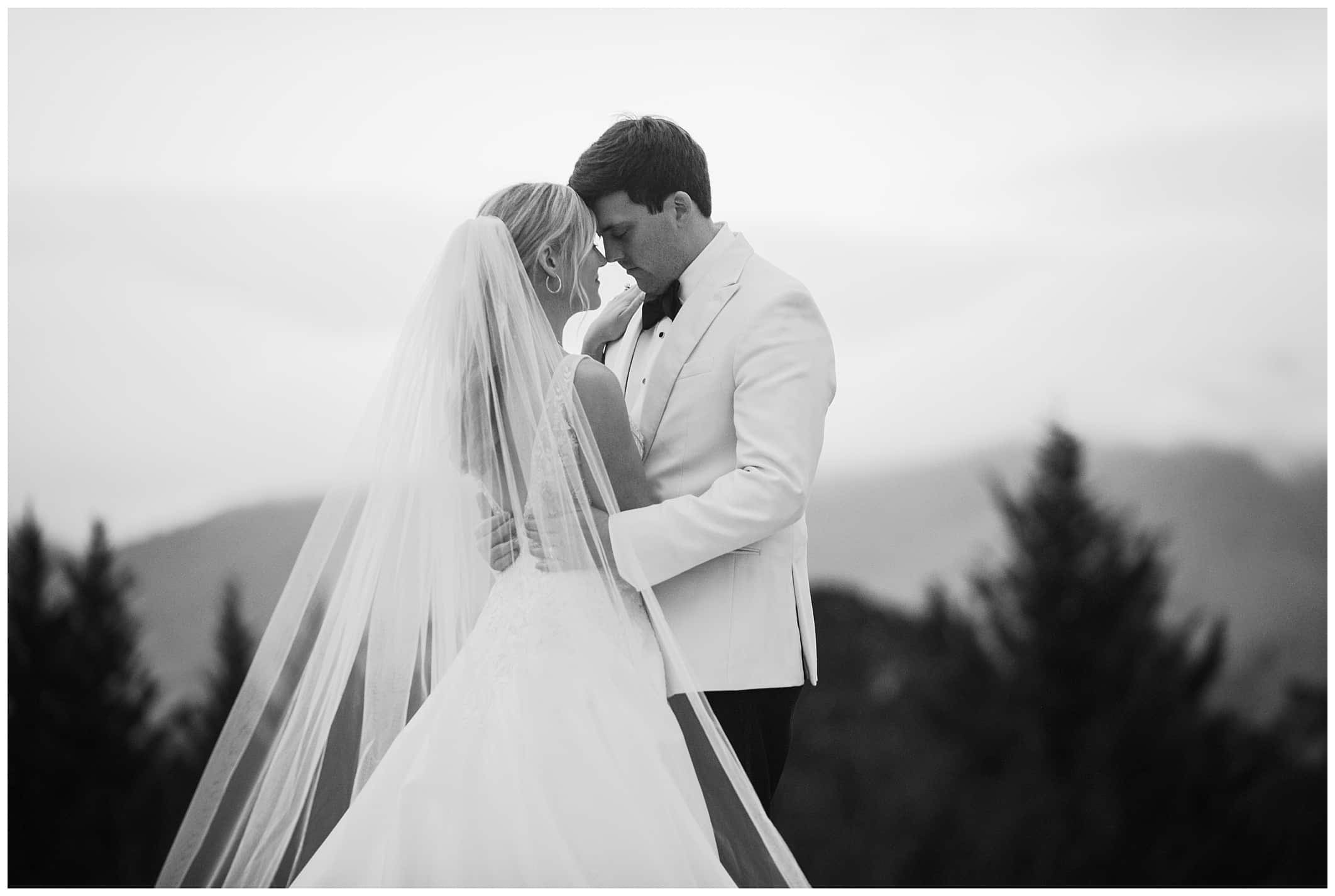 black and white photo of couple posing outdoors for Asheville winter wedding