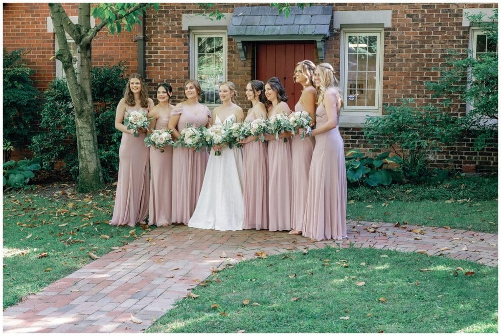 bride and bridesmaids pose outside