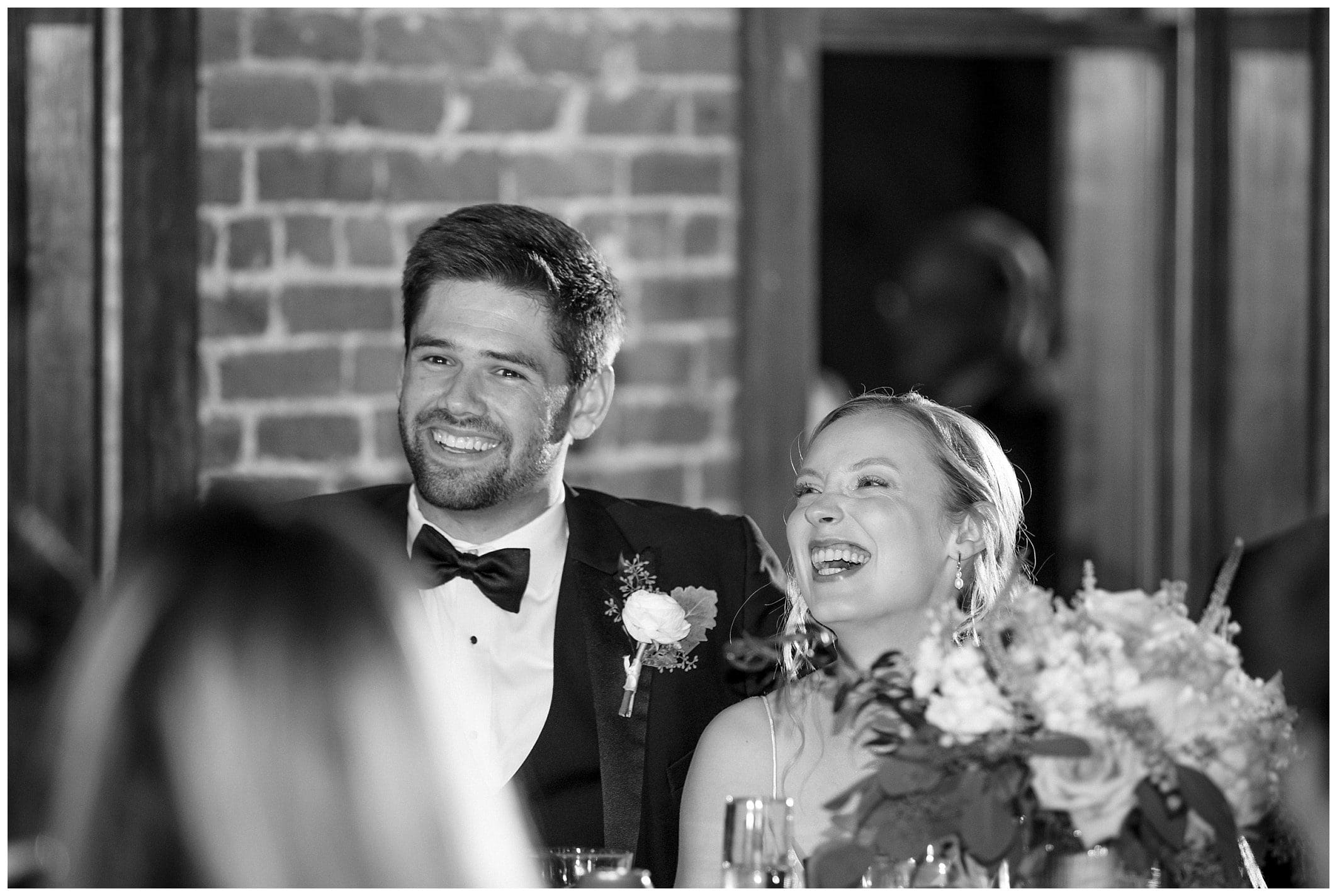 couple laughing at their reception for their Asheville wedding photographer