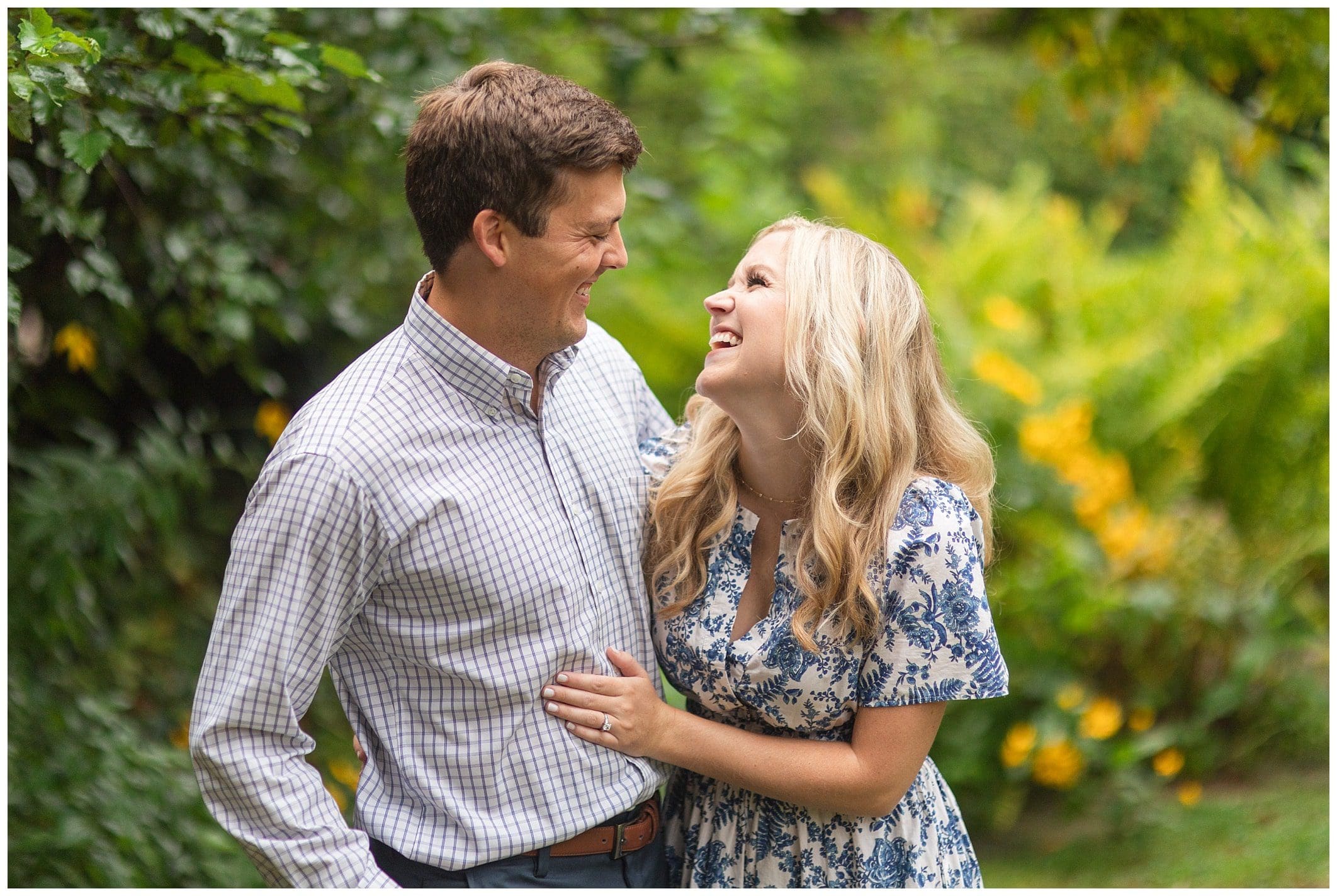 couple laughing for their engagement session outdoors