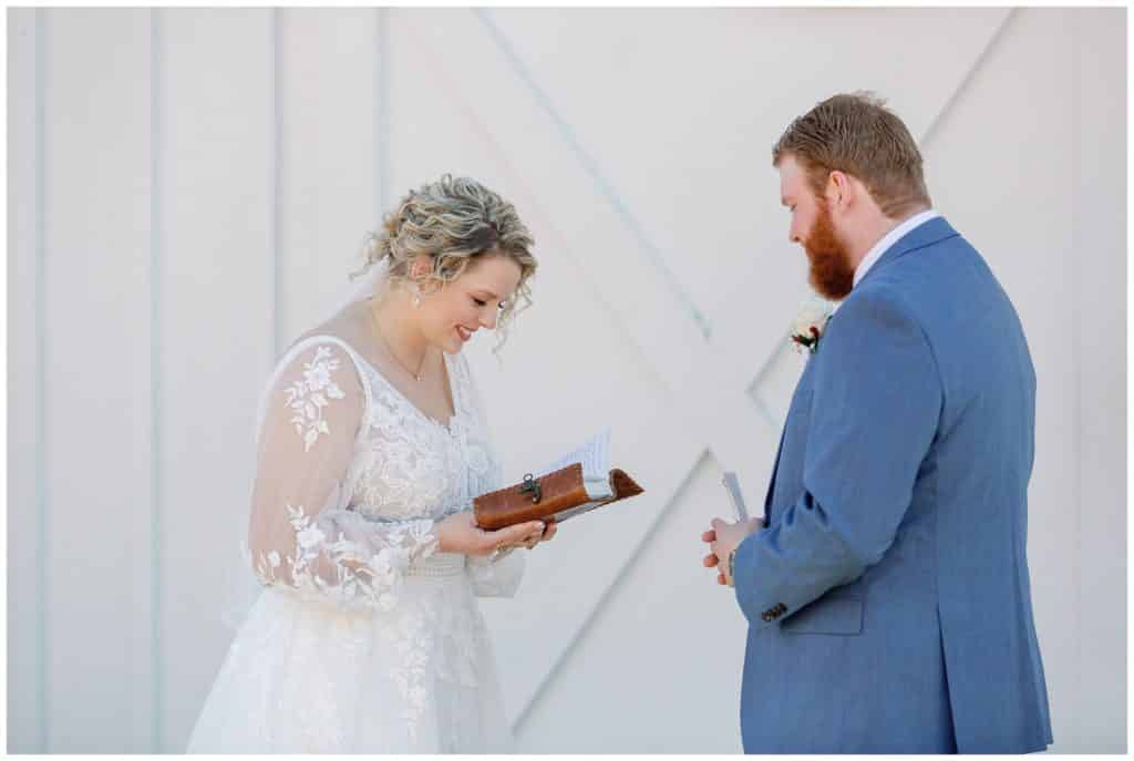 bride and groom read letters to one another on their wedding day