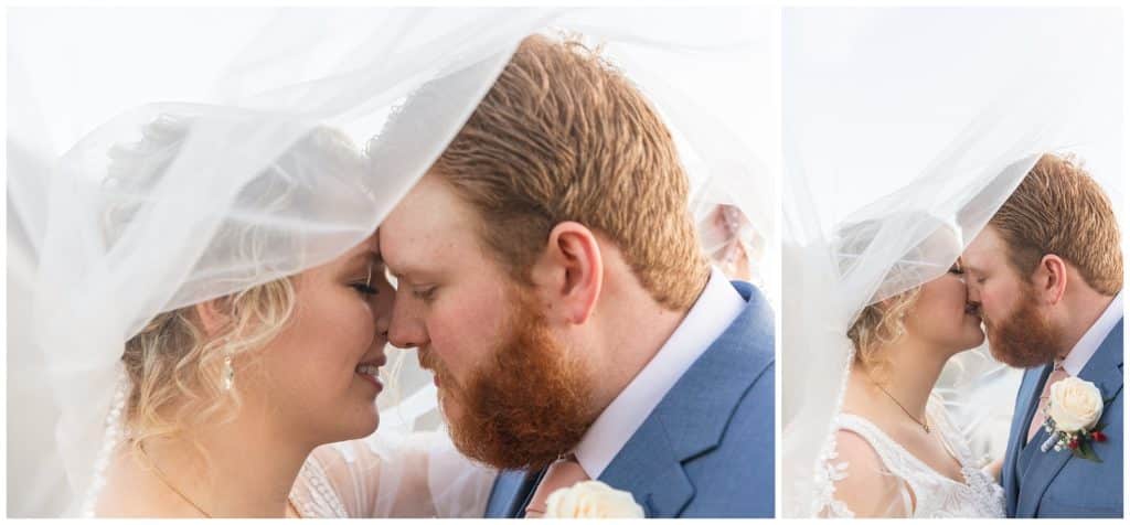 bride and groom share kiss under veil