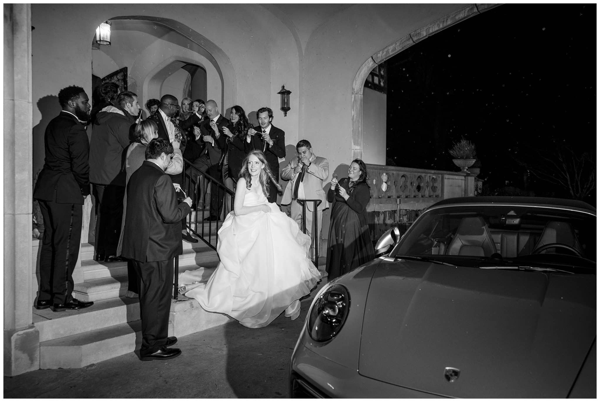 black and white photo of bride and groom making their exit