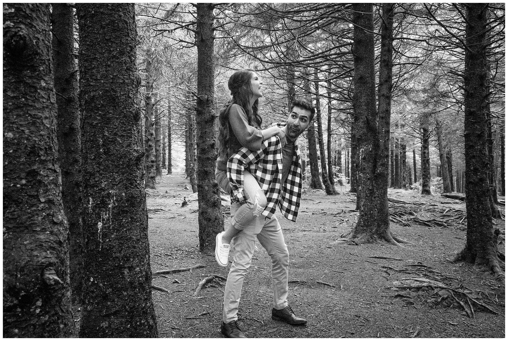 black and white photo of couple being silly for their Asheville engagement session