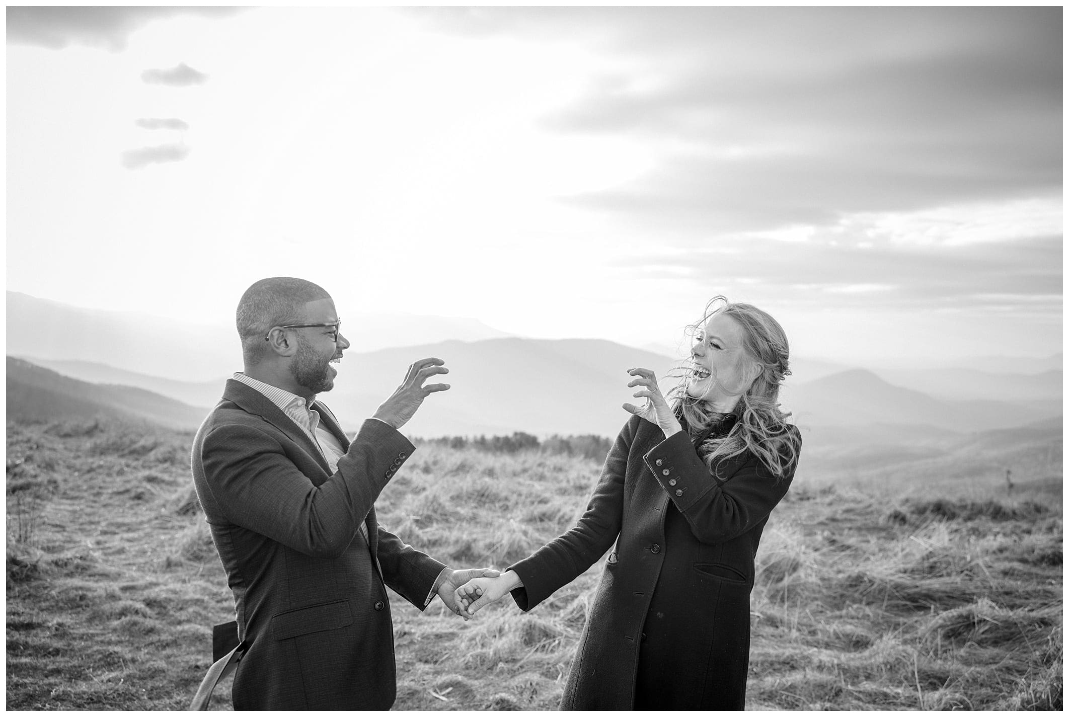 black and white photo of couple laughing during their Asheville engagement
