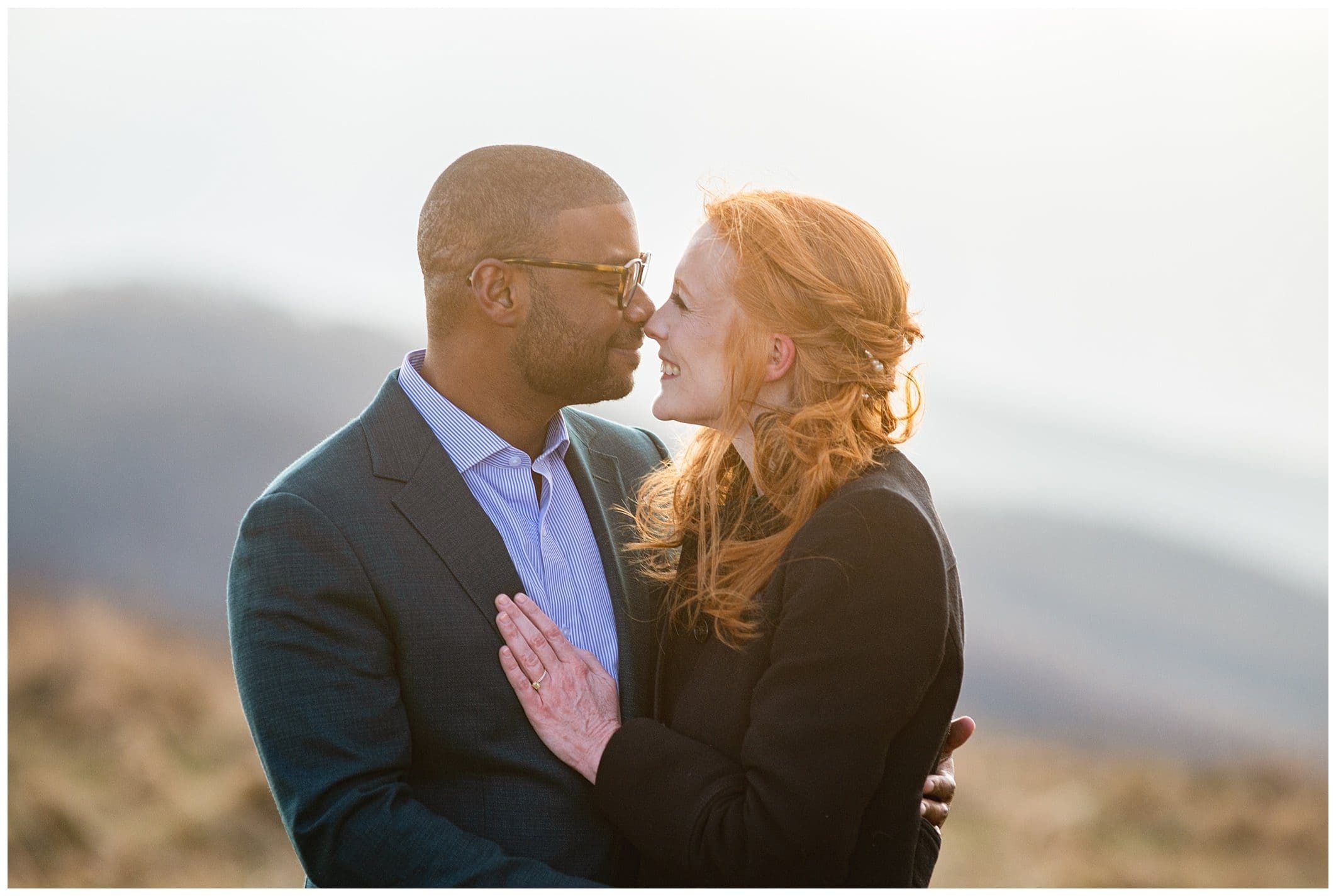 couple cuddles for winter engagement in Asheville 