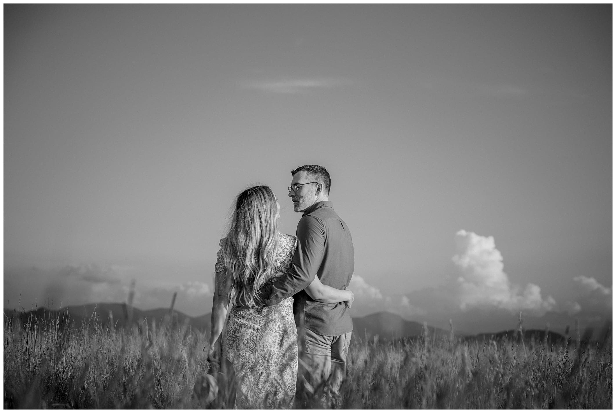 Asheville engagement photographer captures black and white photo of couple at Max Patch