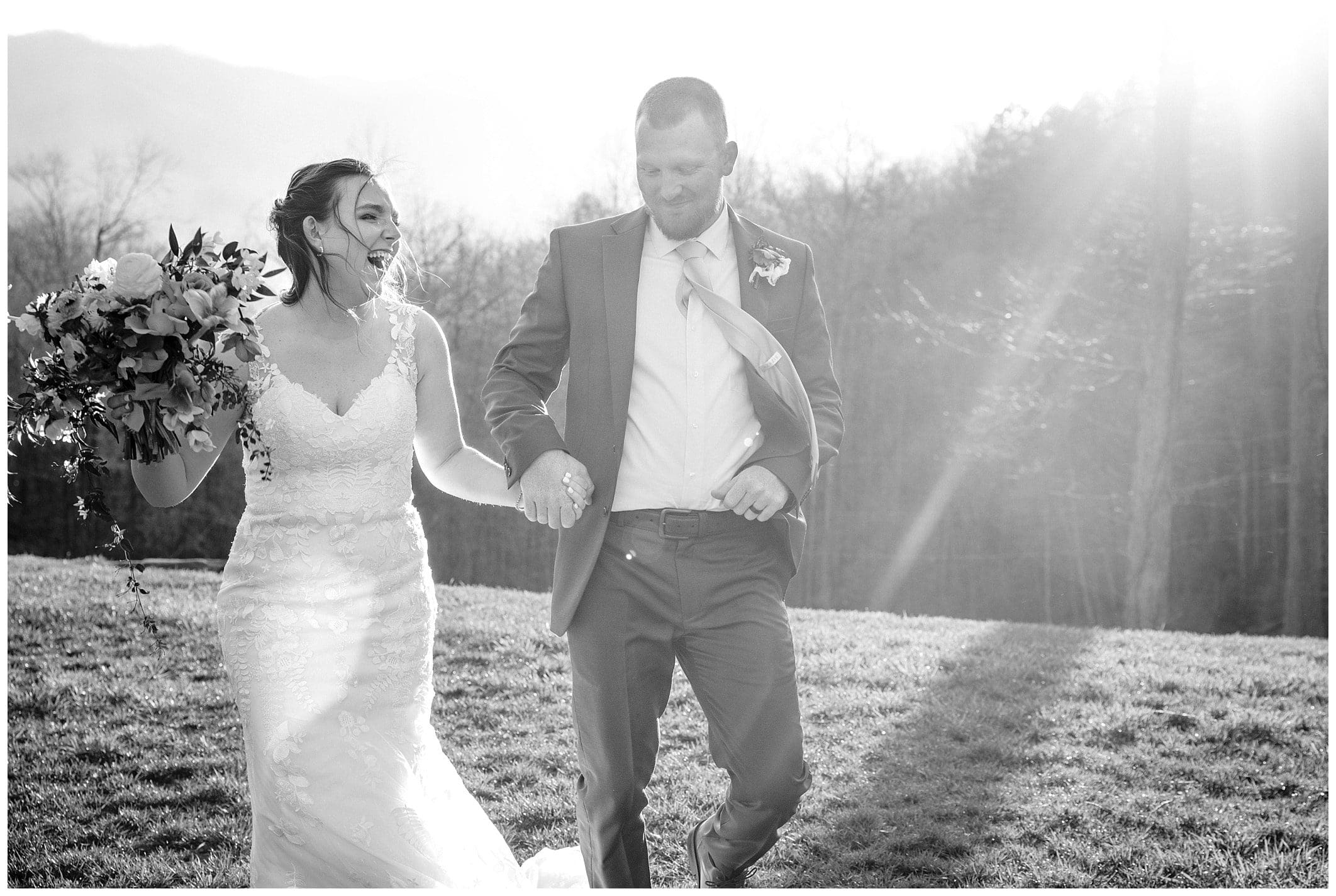 Black and whie joyfful spring wedding with bride and groom holding hands and laughing