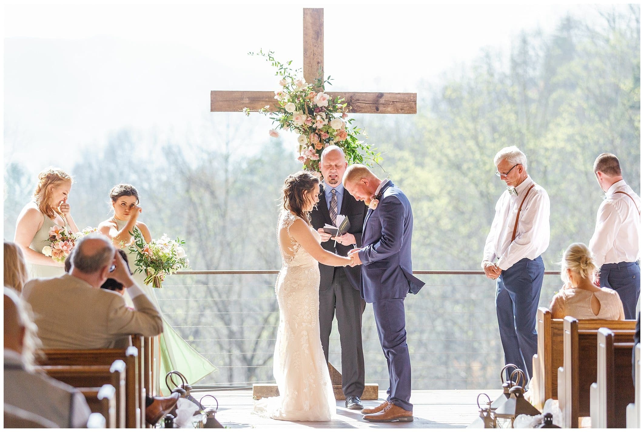 Joyful spring wedding at Parker's Mill overlooking with mountains with the wind blowing.