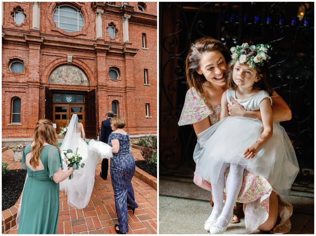 flower girl cuddles with her mother as the bride enters the Basilica of St lawrence wedding