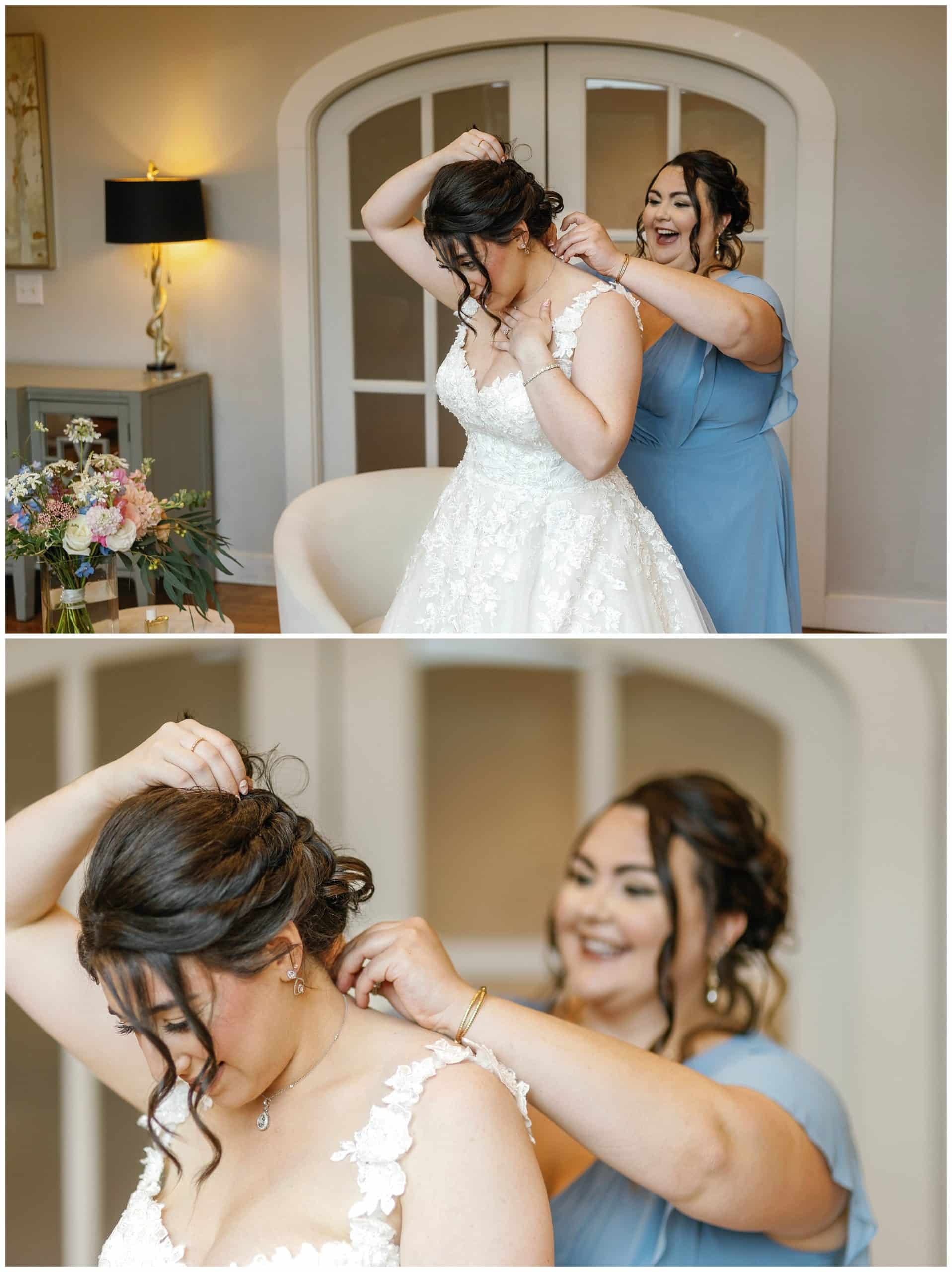Bridesmaid in blue dress helps bride get her necklace.