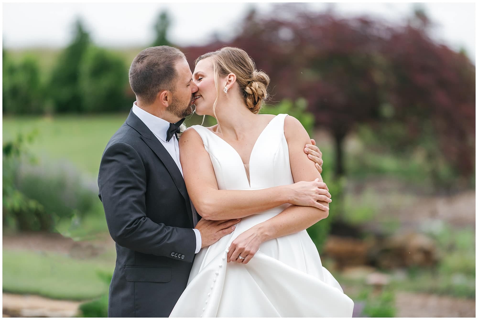 close up photo of bride and groom sharing a kiss 
