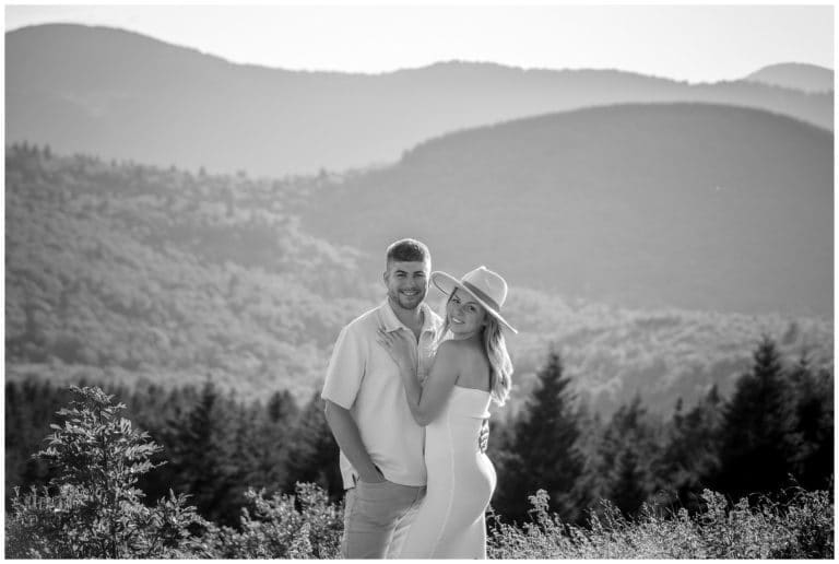 A black and white photo of an engaged couple in the mountains.