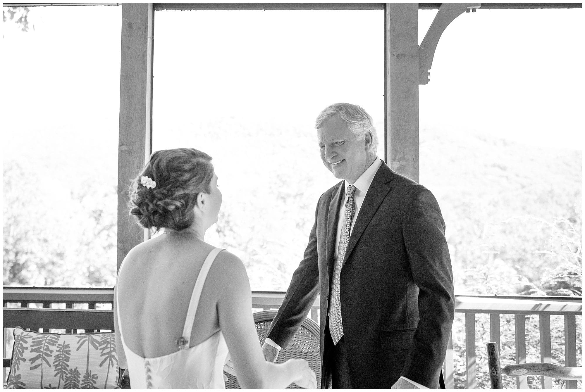 A black and white photo of a bride and her father.